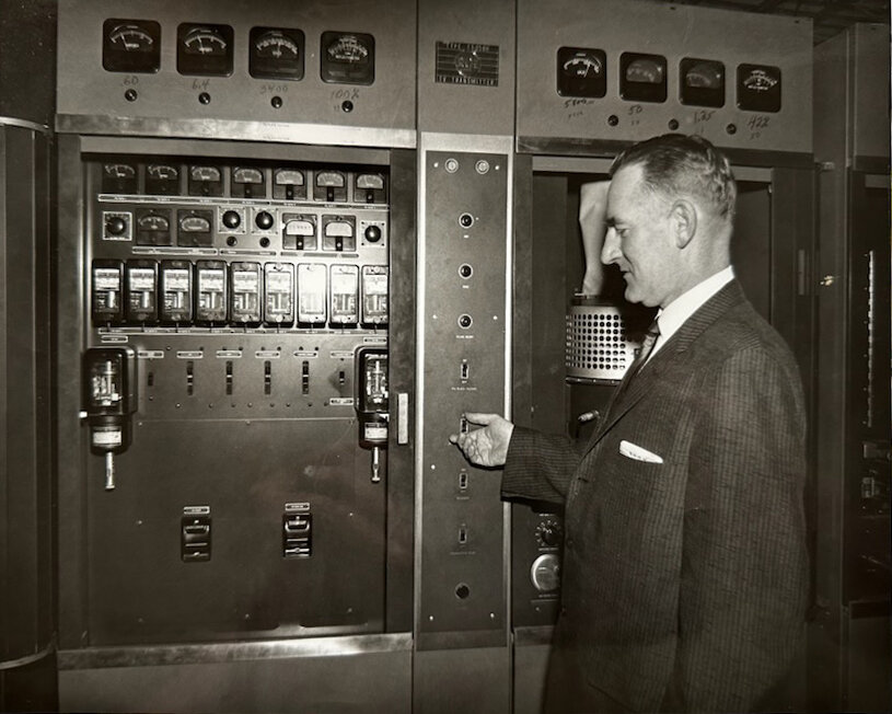 WMBV General Manager Joseph D. Mackin flips a switch on the original transmitter in Oconto in 1954. WLUK photo