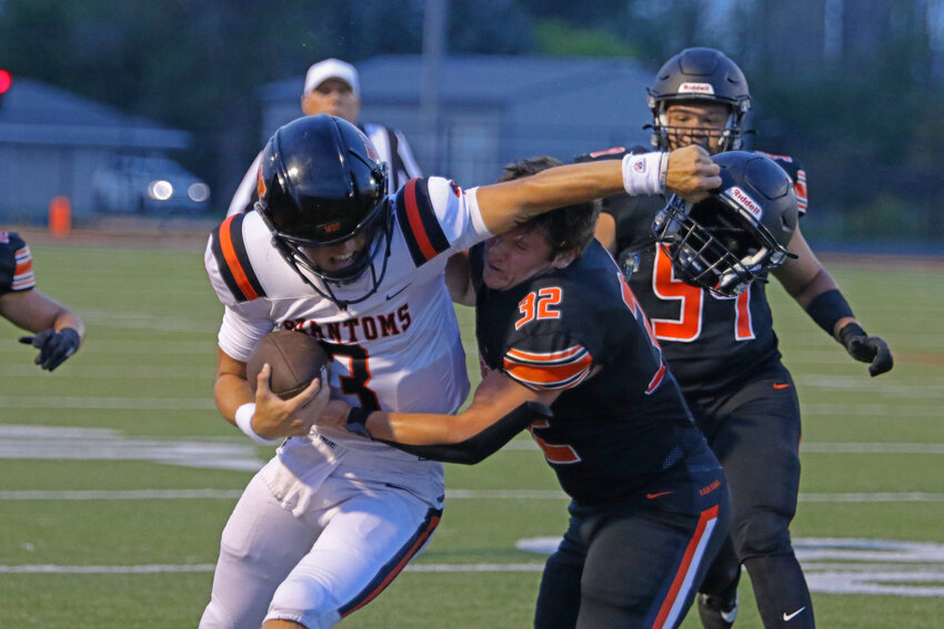 Sam Weber's helmet rolls off as West De Pere's Patrick Greisen moves Weber out of his way.