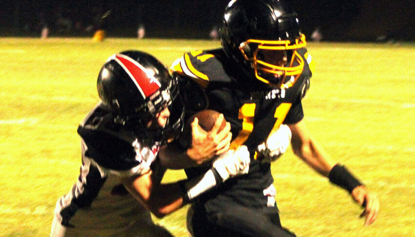 Manawa's Jacob Kravetz tracks down Rosholt quarterback Dylan DeLaet in the second half of Rosholt's 22-12 win over the Wolves..Greg Seubert Photo