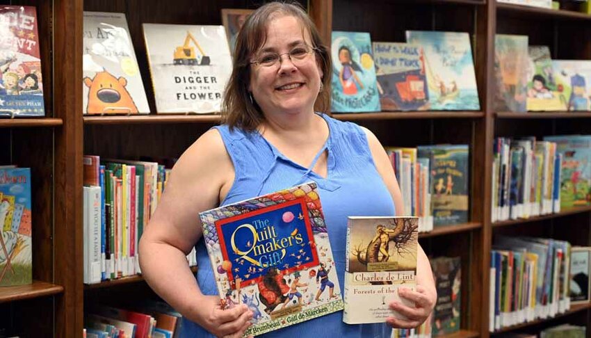 Meredith Miller took over the role of Library Director of the Scandinavia Library in November of 2023, she is pictured here with her favorite children's and adult books.