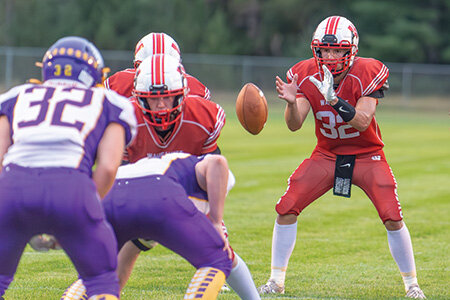 Wausaukee signal caller Luke Smith takes a snap in the first quarter of the Rangers’ game against Suring on Thursday, Aug. 29.