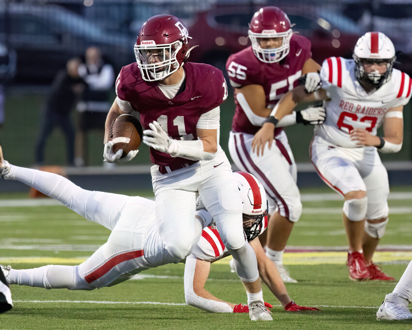 Lucas Koskey bolts for the end zone in a touchdown run during the Redbirds’ 32-14 win over the Red Raiders.