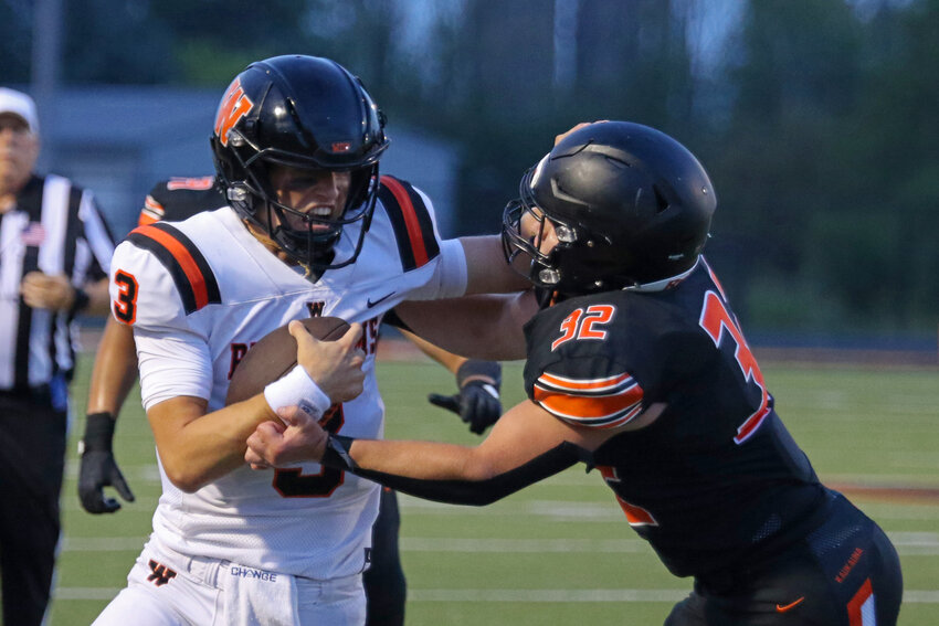 Patrick Greisen fends off Kaukauna's Sam Weber.