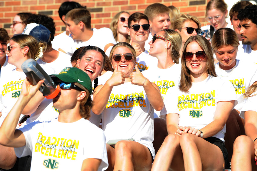 SNC women's soccer players give a thumbs up after receiving a blessing to protect their mental and physical health as they head into their next year of athletics.