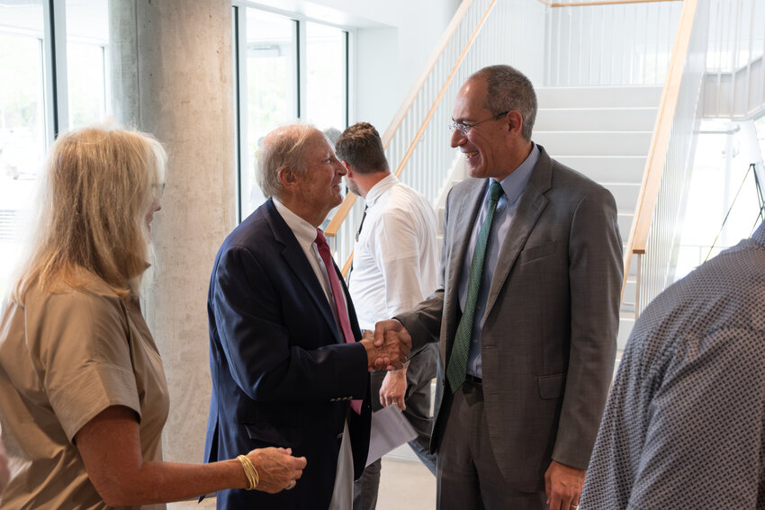 Cort Condon, center, visits with UW-Green Bay Chancellor Michael Alexander, right, at the building dedication.