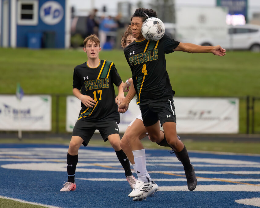 Preble player #4 Huj Chi Vang head the ball to a teammate against Eau Claire Memorial High School.