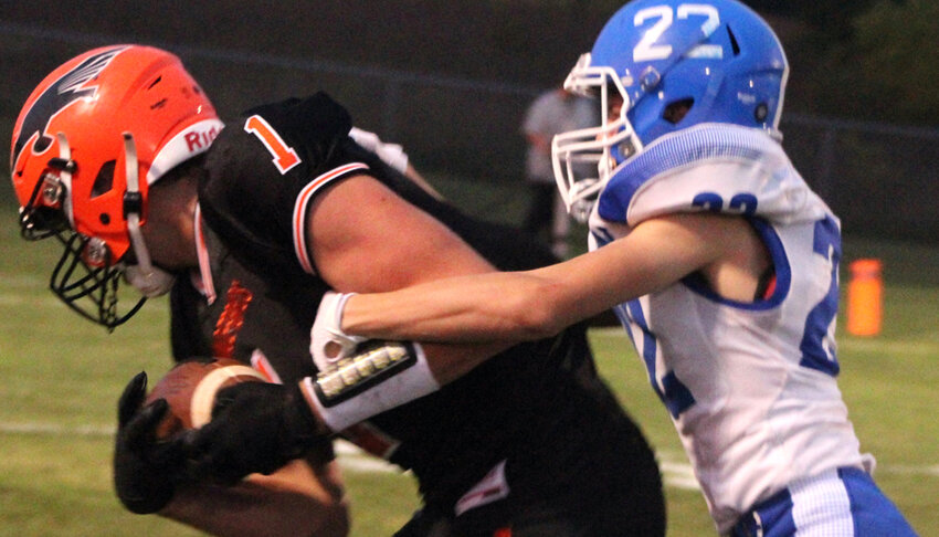 Iola-Scandinavia's Korz Loken breaks away from Assumption's Reid Sauter in the first half of a Central Wisconsin Conference-Small game Sept. 13 in Scandinavia. Loken and the Thunderbirds improved to 3-1 on the season with a 41-0 win over the Royals..Greg Seubert Photo.