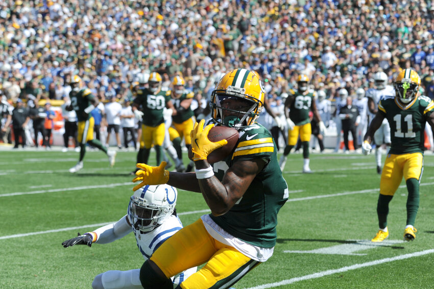 Green Bay Packers Wide Receiver Dontayvion Wicks gets a first down in their game against the Indianapolis Colts. See online gallery for more game day photos.