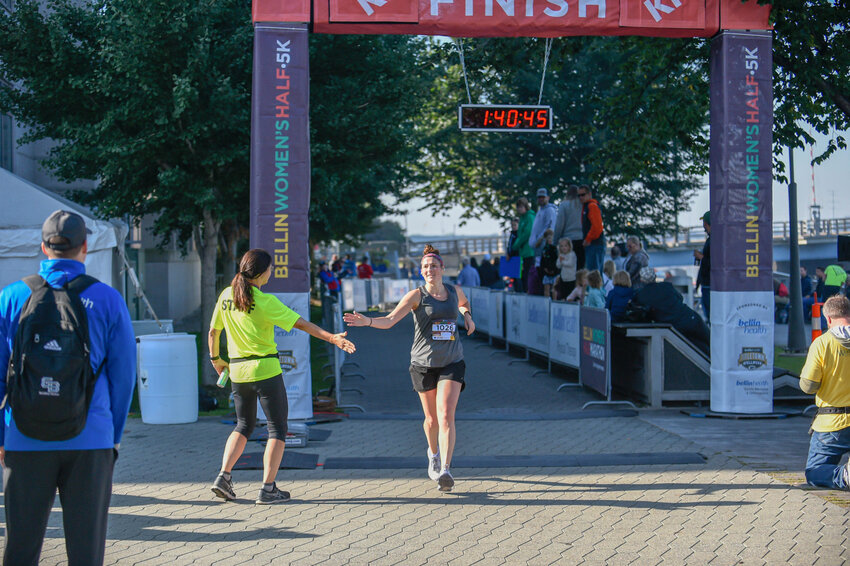 Heather Bills of Green Bay crosses the finish line of the 8th annual Bellin Women's Half Marathon on Saturday, Oct. 1, 2022. With more than 1,000 participants running in the half marathon and 5k events, Bills finished in 12th place in the half marathon with a time of 1:40.44, good enough for 5th place in the 35-39 age group.