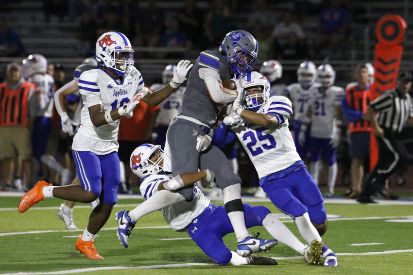 Braxton Murphy protects the ball as Terrors attempt a tackle.