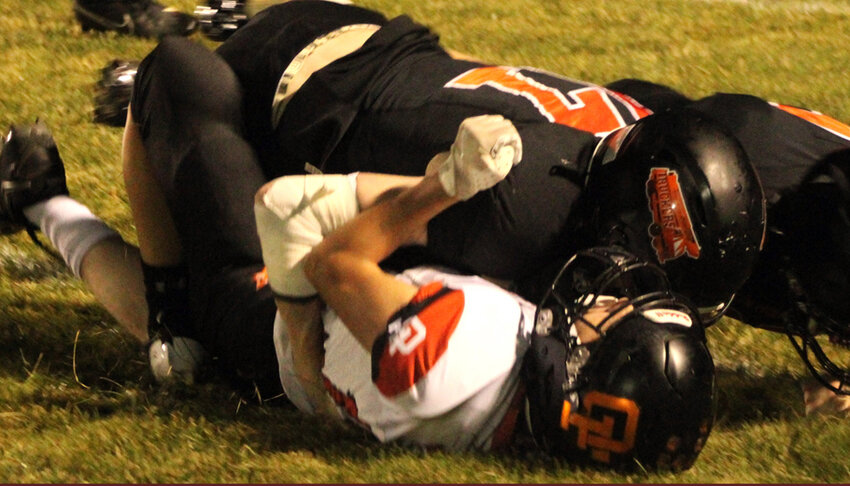 Clintonville's Collin Hill and Levi Wolf team up to tackle Oconto Falls' Connor Ingram in the second half of a Northwoods Conference game at Clintonville High School. Oconto Falls improved to 5-0 on the season Sept. 20 with a 58-0 win over the Truckers..Greg Seubert Photo