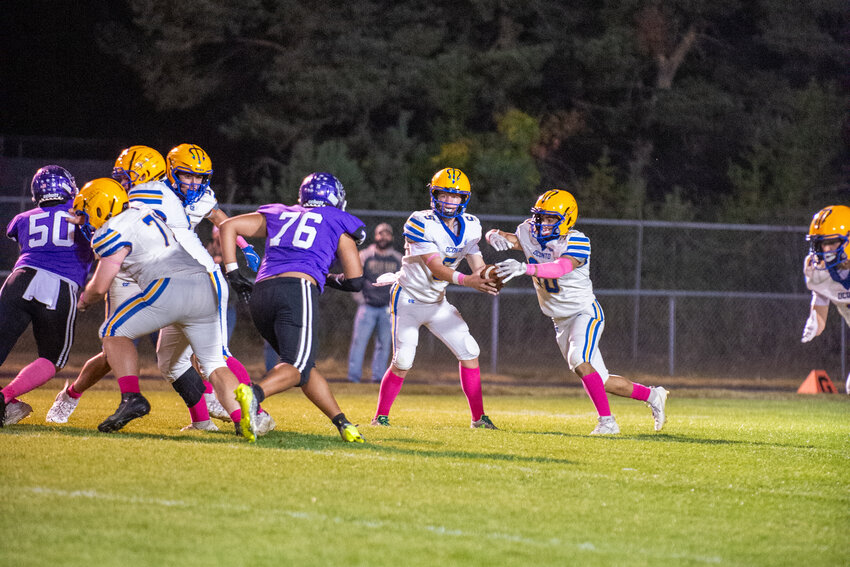 Oconto Running Back Dane Helnore takes a handoff from Quarterback Aiden Hagel.