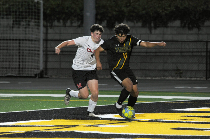 Green Bay Preble's Yosef Navarro looks to get a shot off amid pressure from Manitowoc Lincoln's Eamon Berry in their 2-2 tie on Tuesday, Oct. 8.