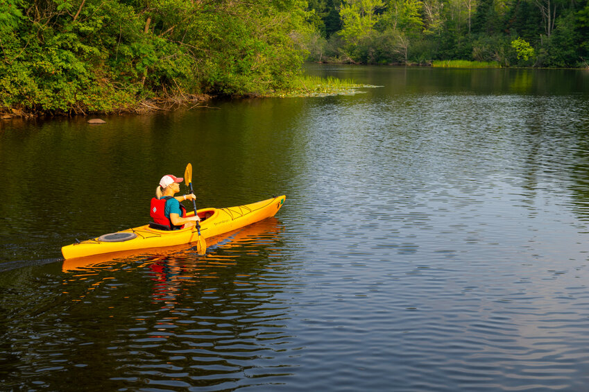 A paddler enjoys the solitude of the Pelican River Forest. This project preserved 70,000 acres of forest land across Langlade, Forest, and Oneida Counties. Photo by  Jay Brittain.