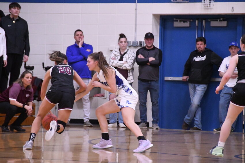 Blazer Ingrid Beaumont looks for an opening in the Wildcat defense as Madi Thomson defends and coach Nicole Natzke looks on.