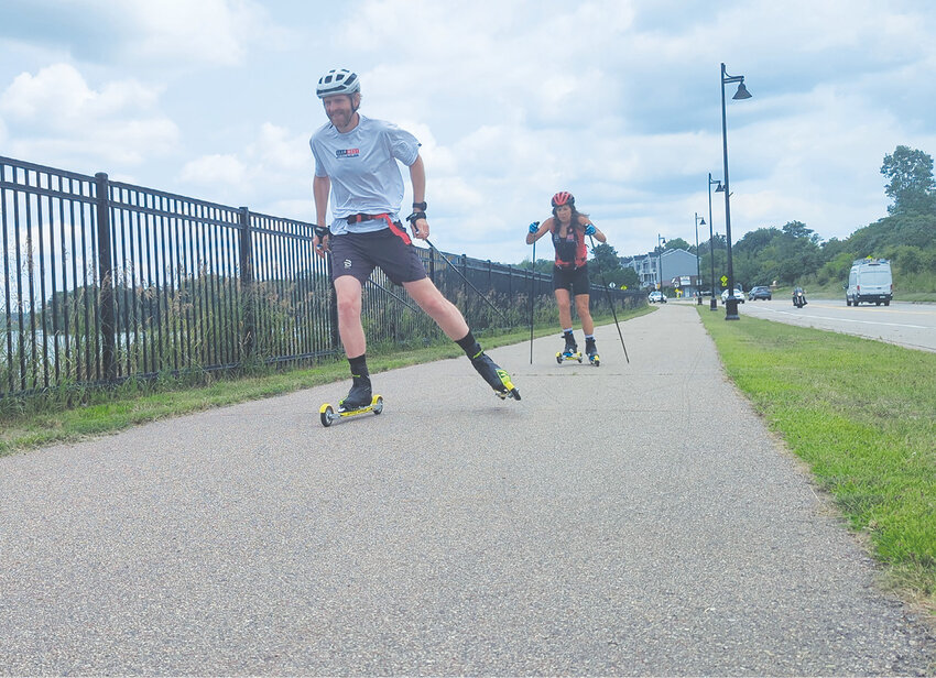 The summertime is perfect to work on ski-specific movements while rollerskiing.  Here, David Chamberlain and Jan Guenther are getting in a quick workout during the workday along Long Lake.