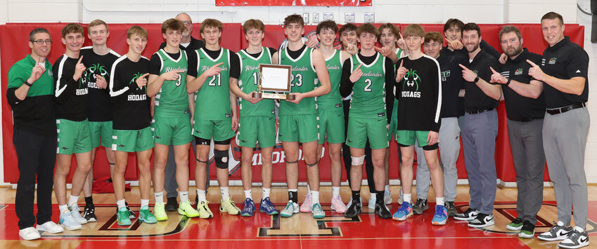 The team and coaches pose with the conference trophy.