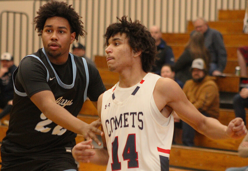 Menasha's Tayden Wilke guards Waupaca's Kanye Bessman in the first half of a WIAA Division 2 state tournament regional game March 4 at Waupaca High School. Bessman finished with 18 points in the Comets' season-ending loss to the Bluejays..Greg Seubert Photo