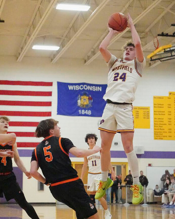 Pioneers Sam Berruecos-Morales, Owen Hendee, and Brayden Lentz fight for the rebound ball over Horicon defense.