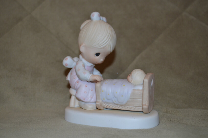 This Precious Moment figurine depicts a loving birthday celebration.