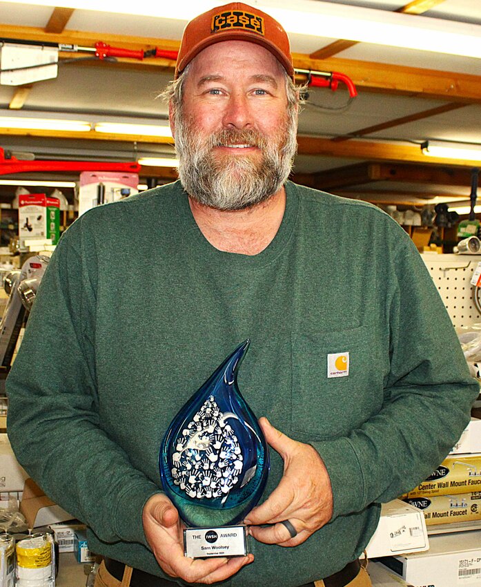 Sam Woolsey shows the award he received in September for his volunteer work to install septic system mounds on a Navajo reservation in New Mexico. Woolsey received the award at a national convention in Las Vegas, Nevada..Greg Seubert Photo