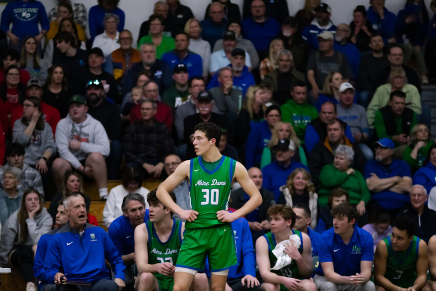 Senior Adam Guyette stands in front of cheering Triton fans while waiting for an inbound pass.
