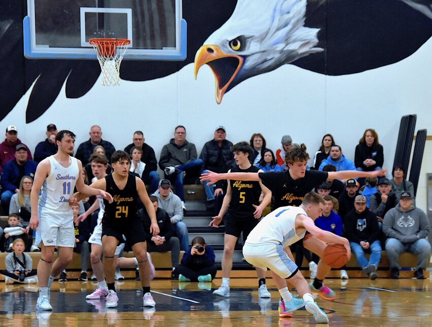Algoma guard Braeden Leist got his foot stepped on by a spinning Drew Daoust in the second half of the Eagles' regional championship win. Also shown (from left) are Tyler Neinas, Lauden Berg, Cody Kirchman and Parker Lischka.