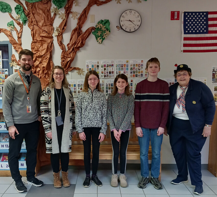 Parkside Principal Mr. Beattie, sixth grade Social Studies teacher Falen Erdman, students Elena Blader, Elyssa Blader, Cullum Cork, and Unit 317 Wautoma Auxiliary Poppy Poster Chairman Julie Vargas.
