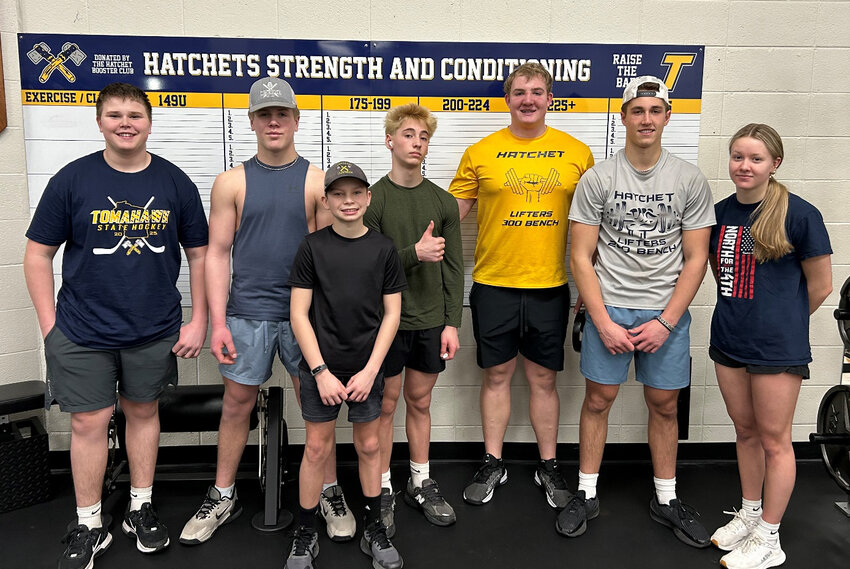 Pictured, with the new Hatchet Booster Club-sponsored lifting max board, are members of the Hatchet Weightlifting Club.