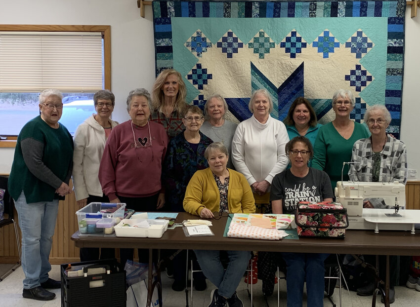 Pine Needle Quilters seated members are Tammy Walters (left) and Diana LaBoeuf (right). Pictured stand (left to right) are Janet DeGrave, Linda Rich, Carol Olson, Katie Lardinois, Mary Ann Dal Santo, Barb Crocker, Jennifer Hall, Dianne Kouski, Betty Thiel and Judy Hoida.