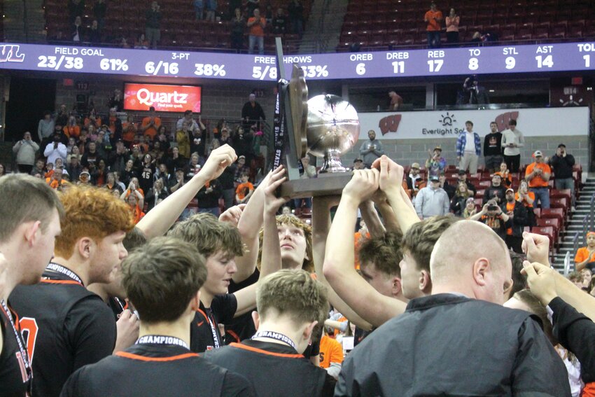 The Marshfield Tigers Boys Basketball team hoists the Silver Ball trophy after their hard-fought 57-55 loss against Wisconsin Lutheran in the WIAA Div. 1 state championship game at the Kohl Center on March 22. Kris Leonhardt photo