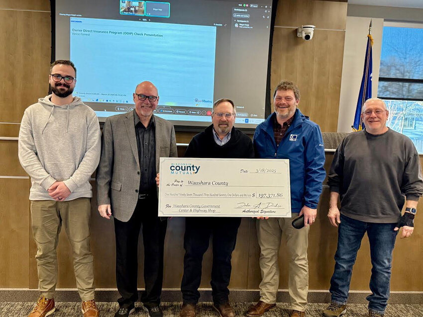 Vance Forrest presented a $197,371.86 check to Waushara County from Wisconsin County Mutual. The check was a dividend returned to the county. The photo includes Brian Winter, Samuel’s Group Assistant Project Manager; Vance Forrest, Vice President of Risk Management for Charles Taylor and administrator for Wisconsin County Mutual; John Jarvis, Waushara County Board Chair and a member Wisconsin County Mutual Board of Directors; Kurt Berner, Samuel’s Vice President; and Tim Nordlund,  Samuel’s Senior Project Manager.