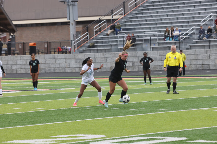 Ella Miljevich dribbles the ball toward the Eau Claire net.