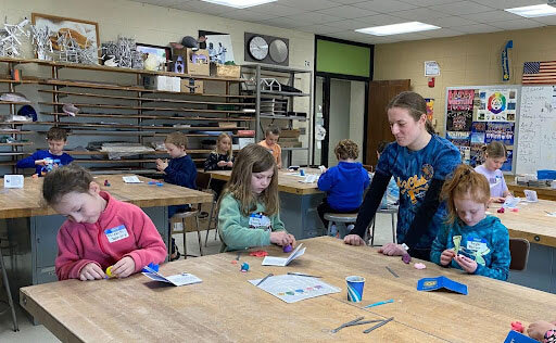 Third, fourth and fifth graders paint, with watercolors, their backgrounds for their African animals paintings.