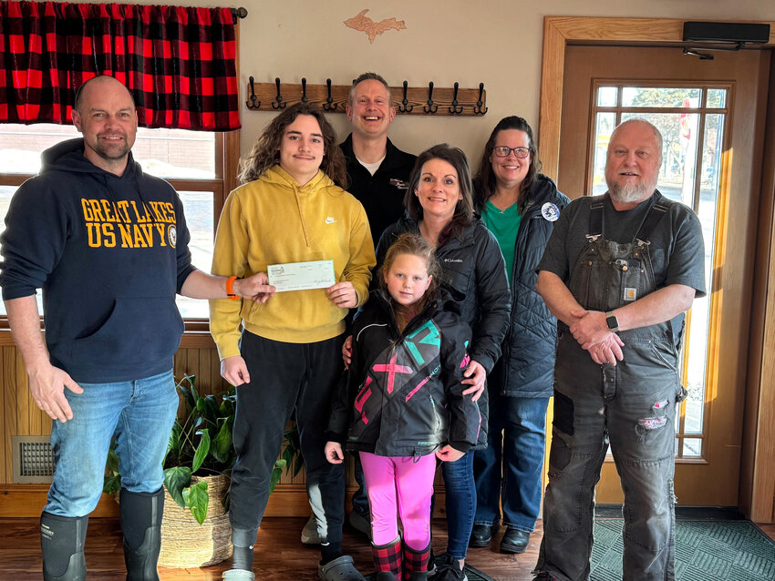 The Crystal Falls / Iron River Masonic Lodge #385 made a donation to the Iron Amateur Hockey Association (IAHA). Pictured are, from left, John Kolbas (Mason), AJ Brunswick (Representing IAHA), Tony Scarlassara (Mason), Kaycee Johnson (Representing IAHA), Tina Brunswick (Representing IAHA) and John Kotcher (Mason). Up front, Aidyn Zimmerman (Representing IAHA).