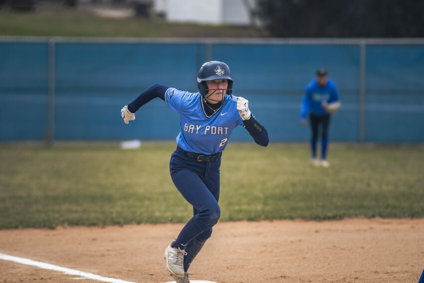 Pirates’ No. 2 Ava Plumley sprints to home plate to score the game's opening run.