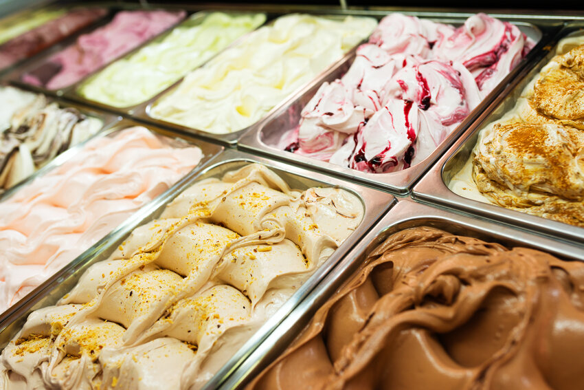 Various Gelato in a store window. Multicolor Ice cream rack in a snack bar.