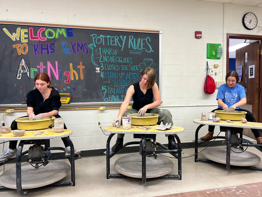 Students from last year's art night demonstrate throwing pottery on a wheel.