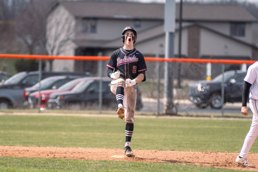 Ryan Wettstein screams in celebration after sliding into second for an RBI double.