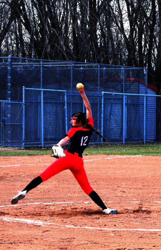 New London's Ellie Winkelman gets into her wind up as she faces Seymour batters..Nick Griesbach Photo