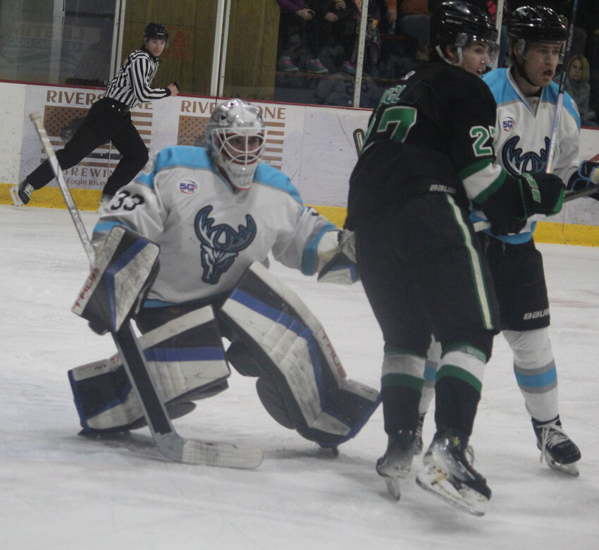 Wisconsin Windigo forward John Halverson attempts to wrap around the net with the puck to score.