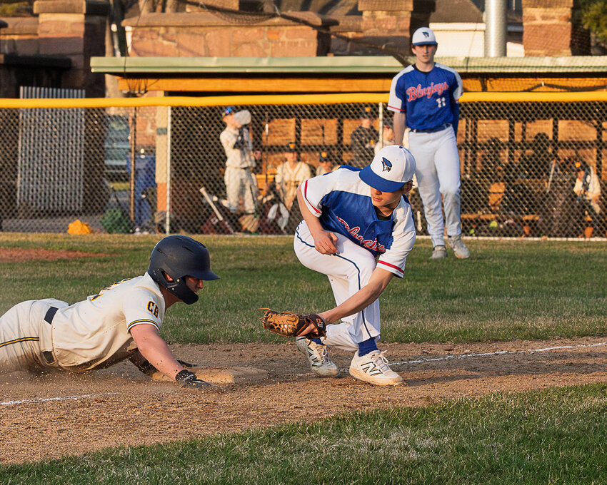 Erik Grunenwald applying tag after the throw from pitcher EJ Weix (in the background).