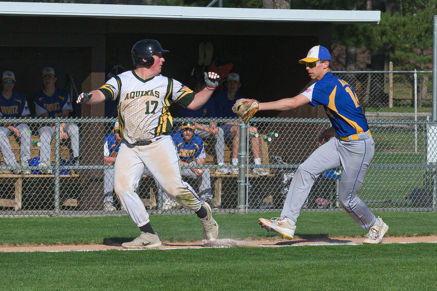 Caught between third base and home plate, Tug Paidl tries to avoid Stephen Allard’s glove but the Wolverines defense would get the out on this play.