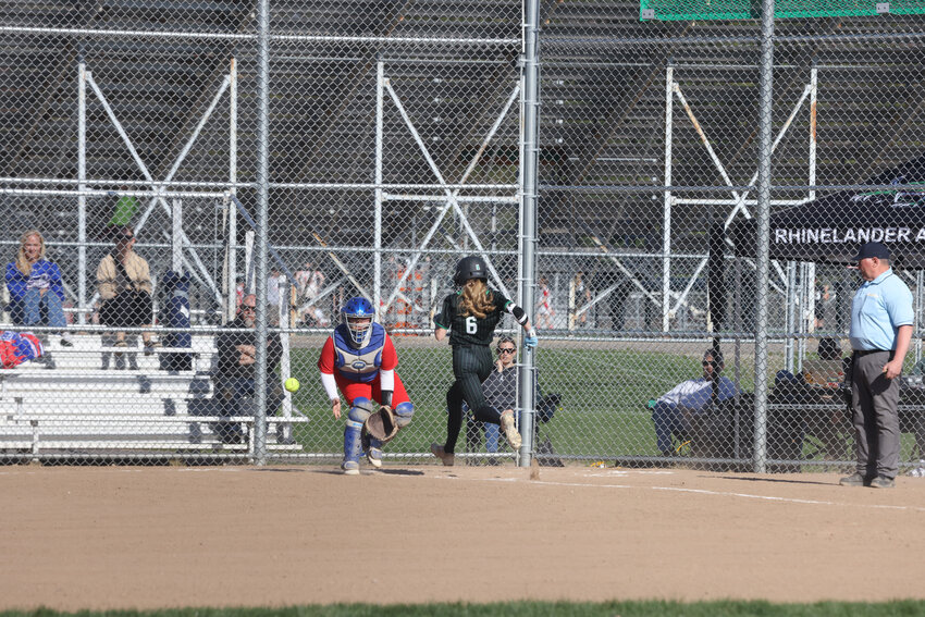 Aleece Johnson beats the throw home on a hit to the outfield.