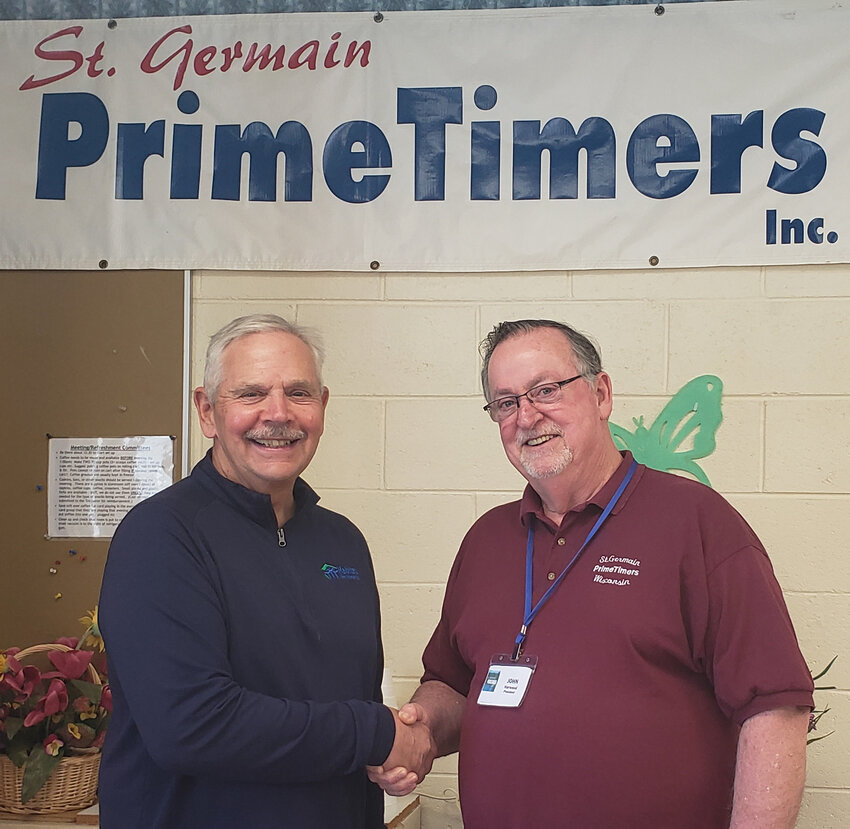 Habitat for Humanity Northwoods Wisconsin Executive Director Dave Havel (left) gave a small presentation to the St. Germain PrimeTimers last Wednesday afternoon about the organization's current building project on Hemlock Lane in St. Germain, and also plans for another project near Sayner. Pictured here is Havel with PrimeTimer President John Harwood. —Staff Photo By JOSEPHINE HINDERMAN