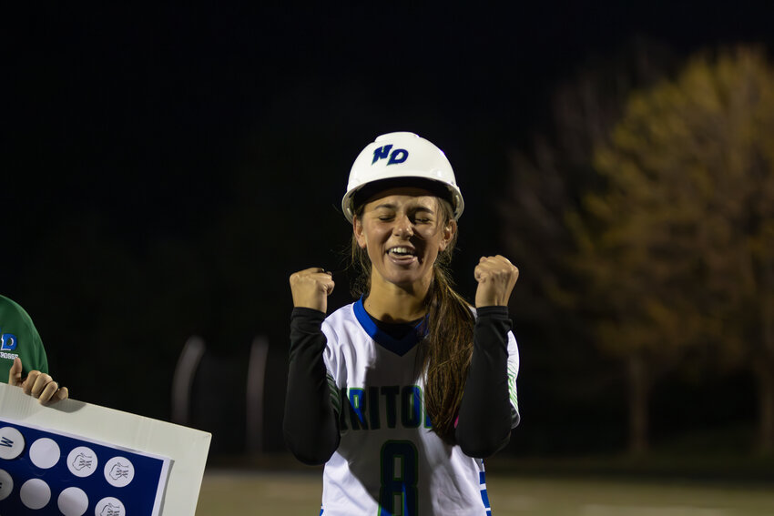 Senior Emily Kukiela celebrates earning the grittiest player of the game hard hat.