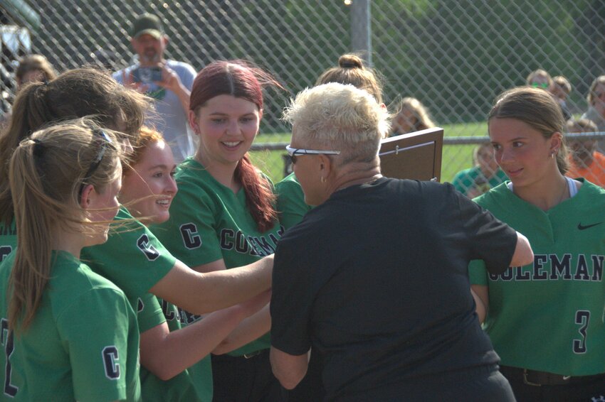 After receiving the M&O conference championship trophy from M&O commissioner Lee Kornaus, Coleman head coach Jean LeVash brings the trophy to her team. The championship marks the 8th straight M&O conference championship secured by the Coleman Cougars.
