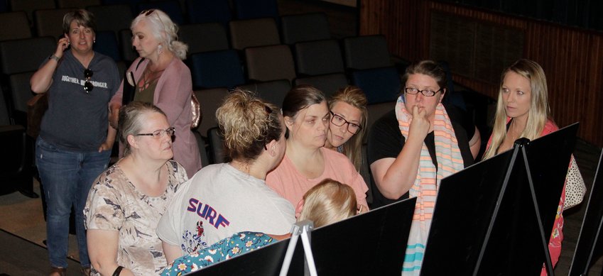 Moberly school district personnel gather at a projected floor plan drawing to share ideas for a newly constructed alternative school during a Tuesday, June 15 public forum on the subject held at the high school auditorium.