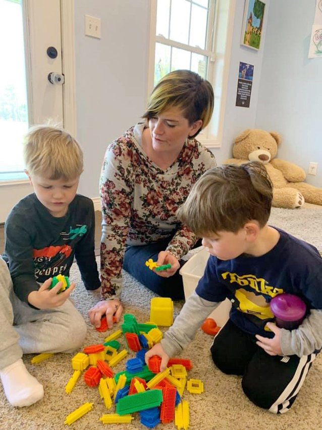 A female student at Primrose Hill Adult &amp;amp; teen Challenge drug and addiction recovery program interacts with young children at its facility located in Clark, Mo. Moberly will host a June 5 BBQ dinner and auction fundraiser for Primrose Hill at the Municipal Auditorium starting at 5:30 p.m.