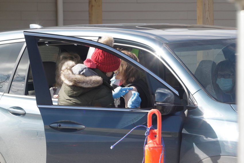 A volunteer healthcare worker administer's a second round of the Pfizer vaccine shot to a patient that attended Randolph County's COVID-19 drive-thru clinic held Feb. 24 at Moberly's Rothwell Park.